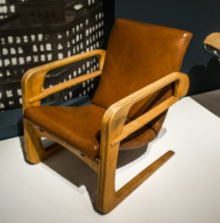 Airline Chair, chair with brown cushions and wooden armrests.