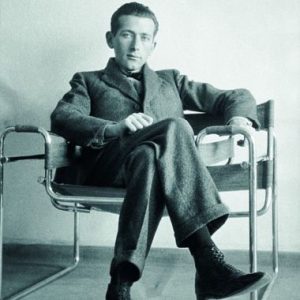 Marcel Breuer sitting on Model B3 Wassily Chair, 1925-26: photo of the man with his legs crossed, looking rather comfortable.