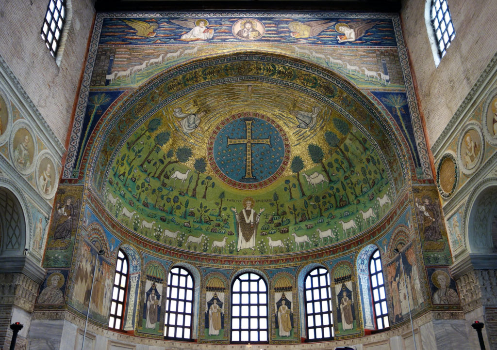 Photo of the mosaic ceiling of the Sant'Apollinare in Classe, Ravenna. The mosaic depicts Jesus under a cross with various vegetation and sheep surrounding him.