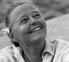 Charlotte Perriand: Portrait of the female architect smiling.